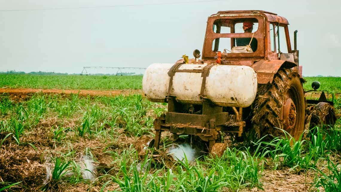 Tractor fumiga un campo de caña en la provicia de Villa Clara