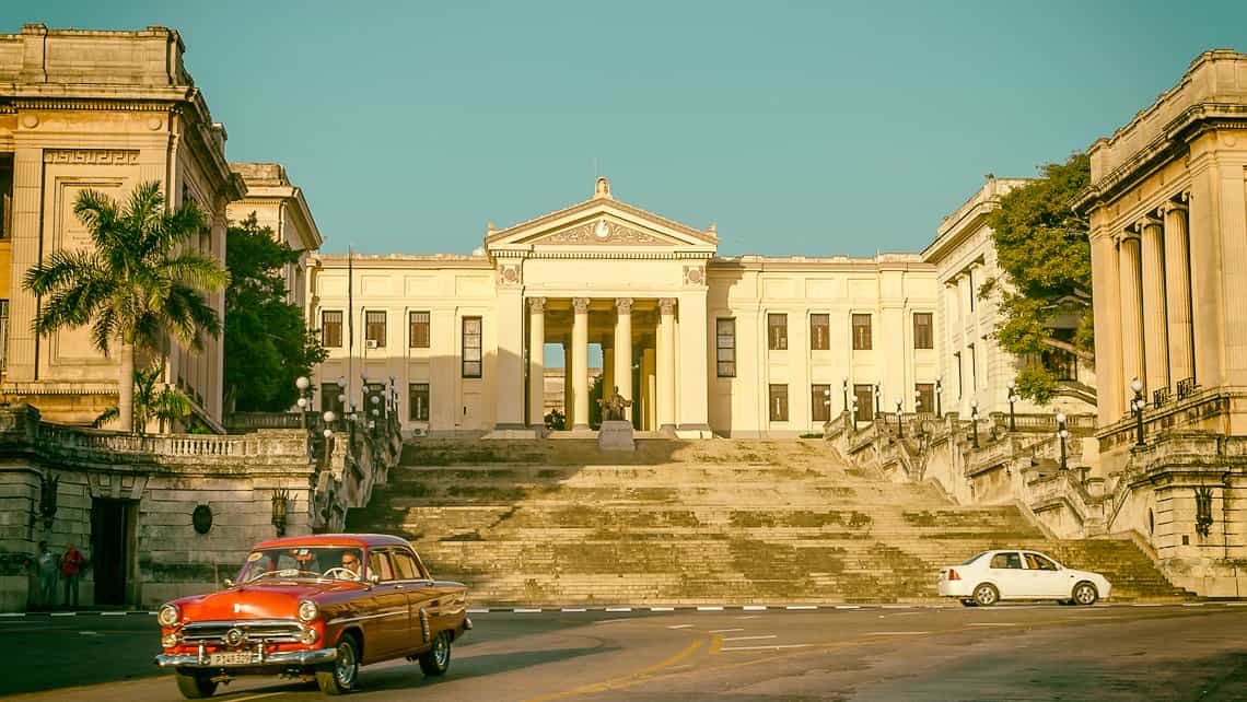 Coche americano de los años 50 recorre la Calle San Lazaro entre el Vedado y Centro Habana, al fondo la Universidad de La Habana
